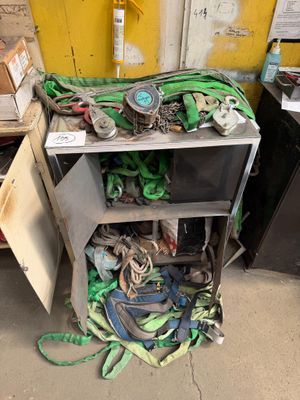 a pile of junk on the ground next to a yellow wall