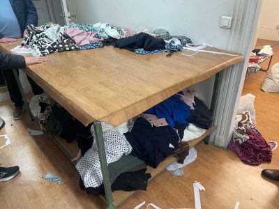 a table that has a bunch of clothes on top of it