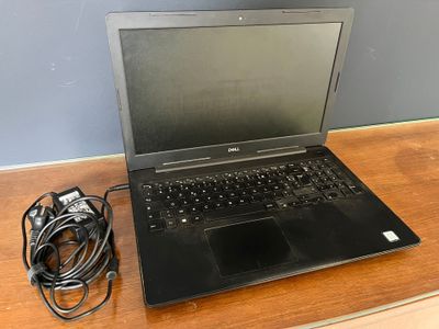 a laptop that is sitting on a table with a charger