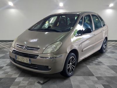 a picture of a small silver car parked in a garage