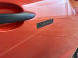 a close up of a car door handle with a sticker on it