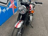 a red motorcycle parked in front of a building