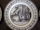 three plates with black and white designs on them on a table