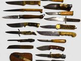 many different types of knives on a white surface