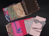 several different colored handkerchiefs laid out on a black surface