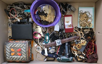 a box full of assorted jewelry and other items