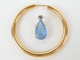 an image of a gold ring with a blue stone in it