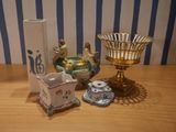 a table with a vase, candle holder, and other items on it