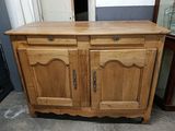a wooden cabinet with a mirror on top of it