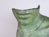 sculpture of a woman ' s face with a green patina finish