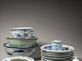 many plates and bowls that are sitting on a table