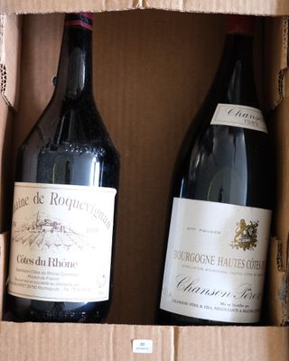 deux bouteilles de vin dans une boîte en carton posée sur une table