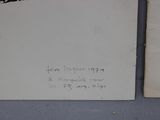 two pieces of paper with writing on them on a table