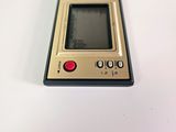 a small electronic device sitting on a white surface