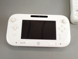 a white nintendo wii game system next to a wii remote