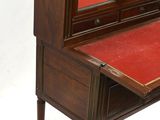 a small desk with a mirror on top of it