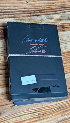 a black box with writing on it sitting on a wooden table