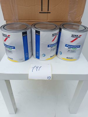 four cans of paint sitting on a table next to a cardboard box