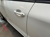 a white car that is parked on the side of the street