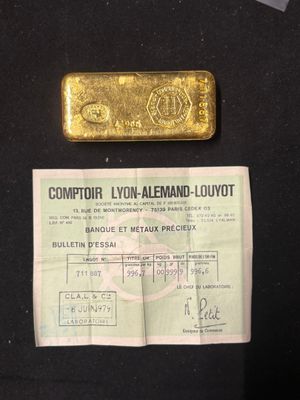 a close up of a piece of gold on a black surface