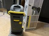a vacuum that is sitting on the floor next to a box