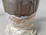 a vase that has a picture of a tree on it