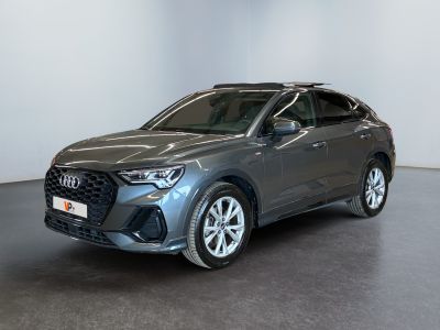 a grey audi suv parked in a room with a black floor