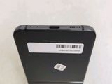 the back of a black cell phone with a barcode on it