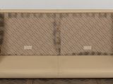 a couch that is sitting on the floor in front of a wall