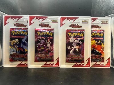 four packs of pokemon trading cards on display on a table