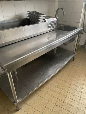 a large stainless steel sink in a commercial kitchen