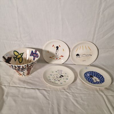 four plates and a bowl on a white table