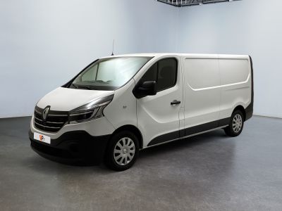 La camionnette blanche est garée dans une grande pièce d'un immeuble.