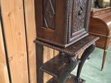 a wooden shelf with a wooden cabinet on top of it