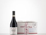 bottle of red wine next to a box of wine on a table
