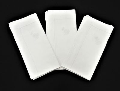 trois feuilles de papier blanc posées sur une surface noire