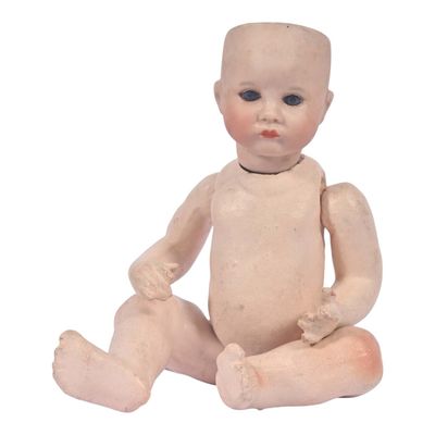 a small doll that is sitting on the ground