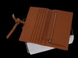 leather wallet on a black background with a notepad in the corner