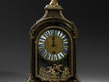 a clock that is sitting on a stand with a bird on it