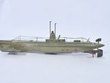 a toy boat that is sitting on a white surface