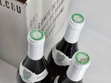 three bottles of wine sitting next to each other on a table