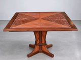 an image of a wooden table with a square top on a concrete floor