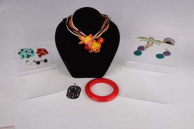 un collier, un bracelet, une bague et d'autres bijoux exposés