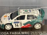 a toy car in a clear display case on a table