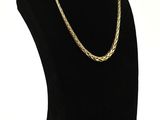 a black mannequin with a gold chain on a white background