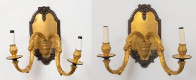 two wall sconces that are attached to the wall