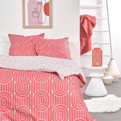 un lit recouvert d'une couette rouge et blanche
