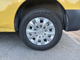 a yellow car that is parked on the side of the road
