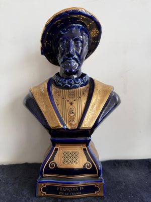 a blue and gold bust of a man with a hat on