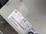 a sticker on the back of a machine that is sitting on the ground